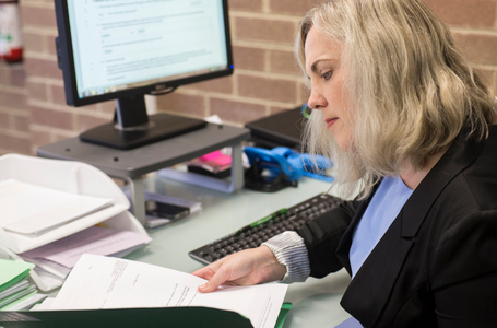 A conveyancer perusing a document regarding a property sale